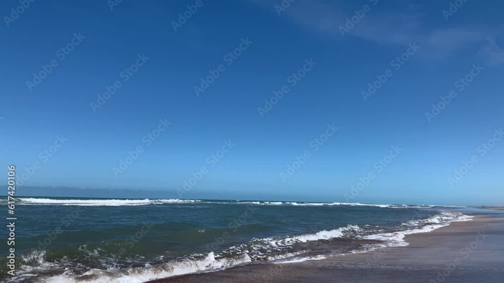 Small sea waves come to shore on a summer day. Small sea waves come to shore on a summer day.