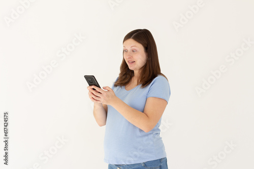 Portrait of attractive focused cheerful pregnant girl using device app chatting isolated over white color background