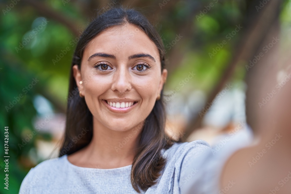 Young beautiful hispanic woman smiling confident making selfie by camera at park Young beautiful hispanic woman smiling confident making selfie by camera at park