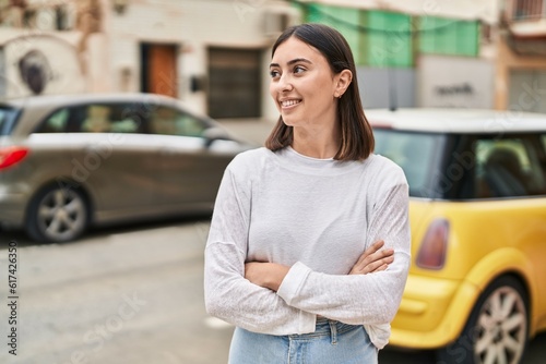 Young hispanic woman smiling confident standing with arms crossed gesture at street © Krakenimages.com