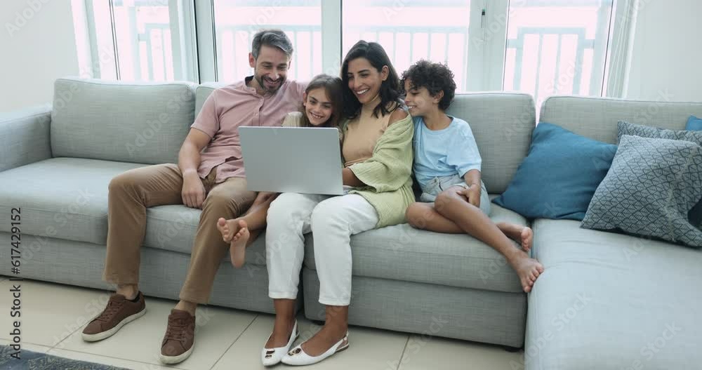 Happy multinational family using laptop at home. Children and parents watch on-line TV movie or cartoons using digital streaming services, buying tickets, planning travel enjoy free time on internet Happy multinational family using laptop at home. Children and parents watch on-line TV movie or cartoons using digital streaming services, buying tickets, planning travel enjoy free time on internet