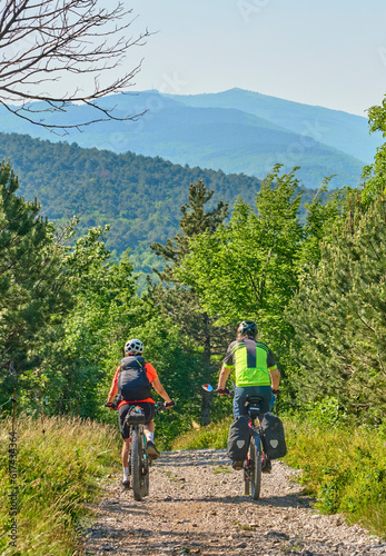 active senior couple on a bike tour with their electric mountain bikes in the Karst Mountains of Slovenia near Solkan