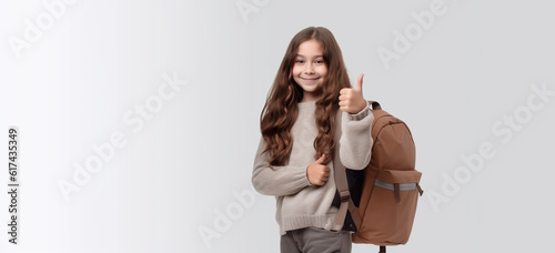 A little girl smiling in her way back to school with a bagpack .  Image generative AI. photo
