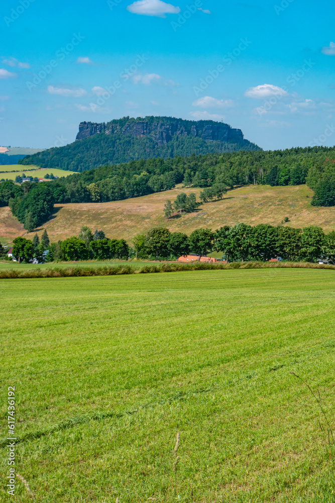 Königstein, Saxony, Germany. View Lilienstein mount in the national park Saxon Switzerland by Elbe river and green countryside fields and forests