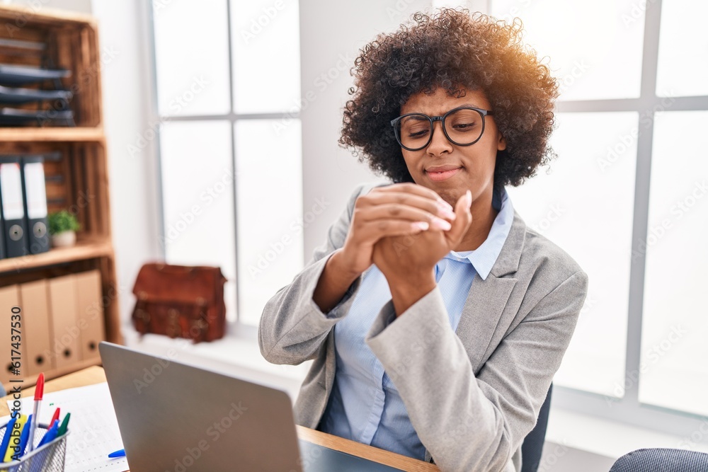 African american woman business worker suffering for hand pain working at office African american woman business worker suffering for hand pain working at office