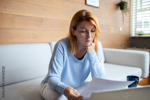 Mid adult woman going over bills at home
