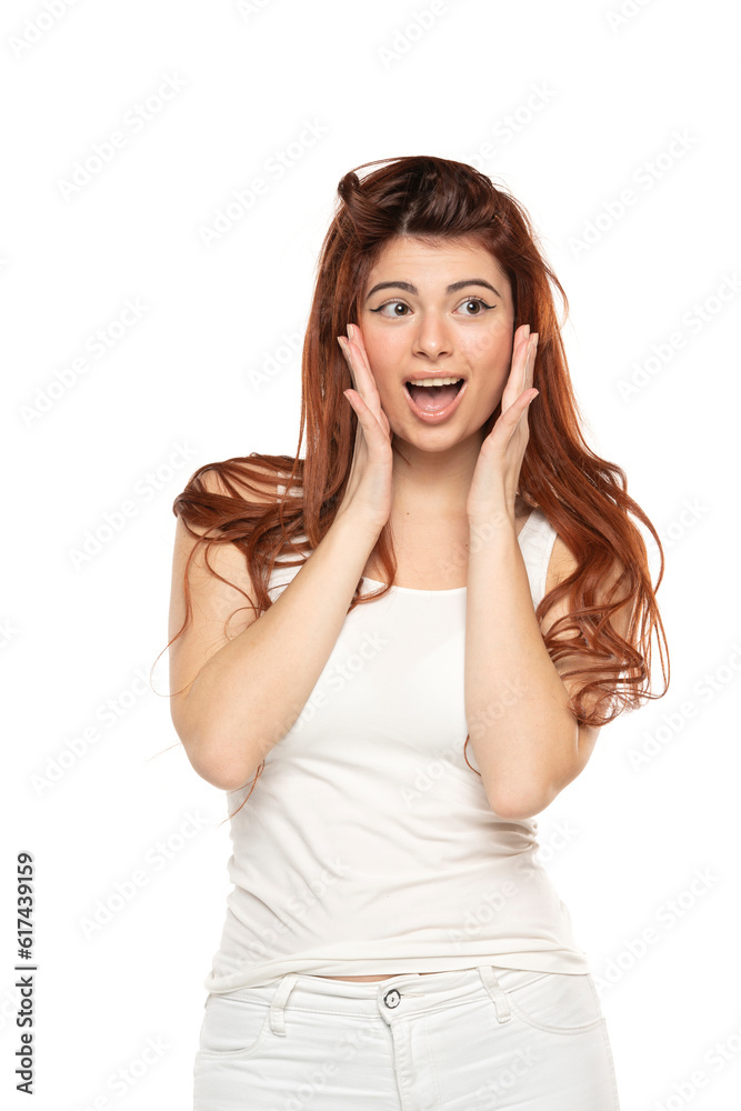 Portrait of surprised beautiful woman with long straight ginger hair on a white background Portrait of surprised beautiful woman with long straight ginger hair on a white background