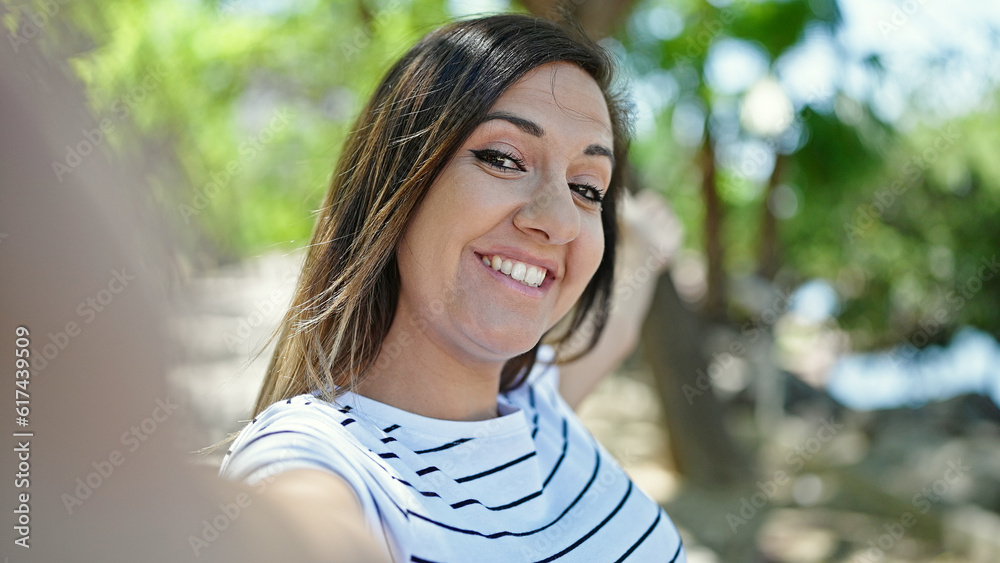 Middle eastern woman smiling confident making selfie with camera at park Middle eastern woman smiling confident making selfie with camera at park