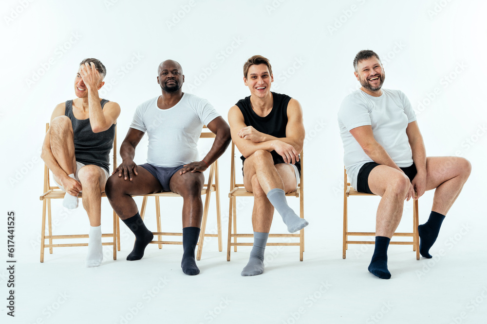 Obraz premium multiethnic men posing for a male edition body positive beauty set showing messages on banners. Shirtless guys with different age, and body wearing boxers underwear