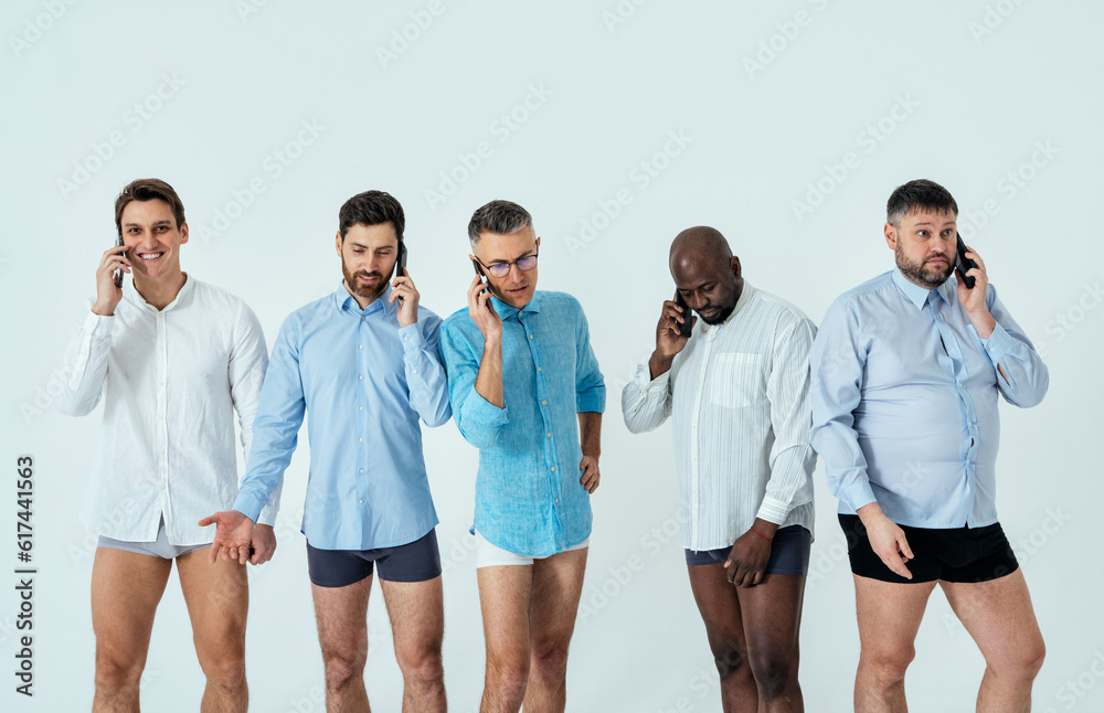 multiethnic men posing for a male edition body positive beauty set showing messages on banners. Shirtless guys with different age, and body wearing boxers underwear multiethnic men posing for a male edition body positive beauty set showing messages on banners. Shirtless guys with different age, and body wearing boxers underwear
