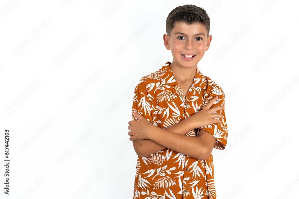 Little hispanic boy wearing hawaiian shirt happy face smiling with crossed arms looking at the camera. Positive person. Little hispanic boy wearing hawaiian shirt happy face smiling with crossed arms looking at the camera. Positive person.