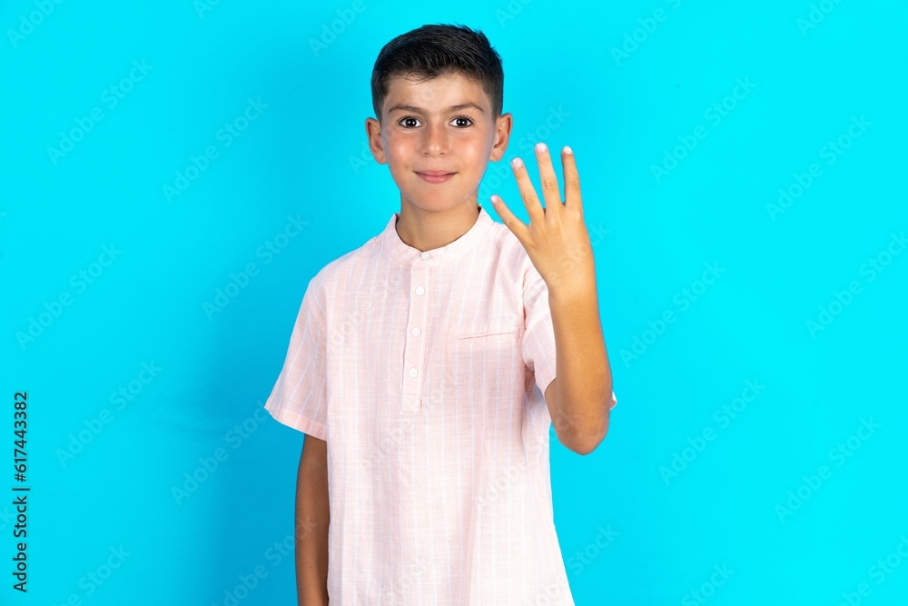 Little hispanic boy wearing white shirt smiling and looking friendly, showing number four or fourth with hand forward, counting down Little hispanic boy wearing white shirt smiling and looking friendly, showing number four or fourth with hand forward, counting down