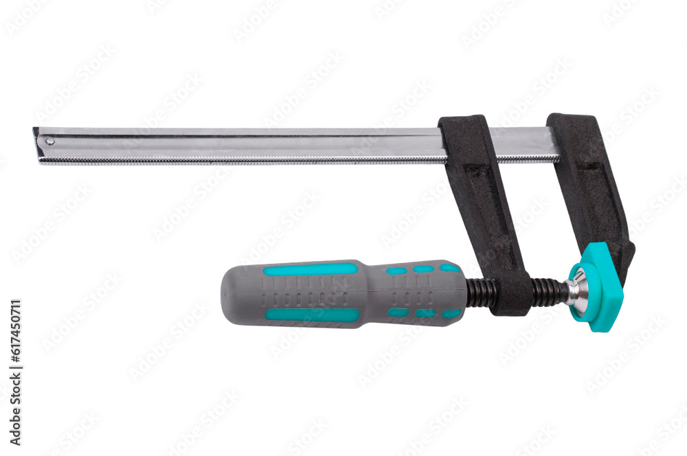 metal adjustable clamp on a white background. industrial powerful clamp on the table. wood gluing concept. fixing device on a work texture metal adjustable clamp on a white background. industrial powerful clamp on the table. wood gluing concept. fixing device on a work texture