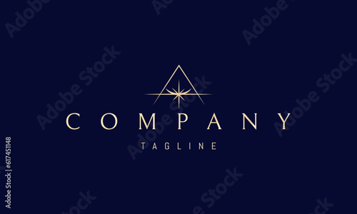 Vector golden logo on which an abstract image of a shining star against the background of a pyramid silhouette.