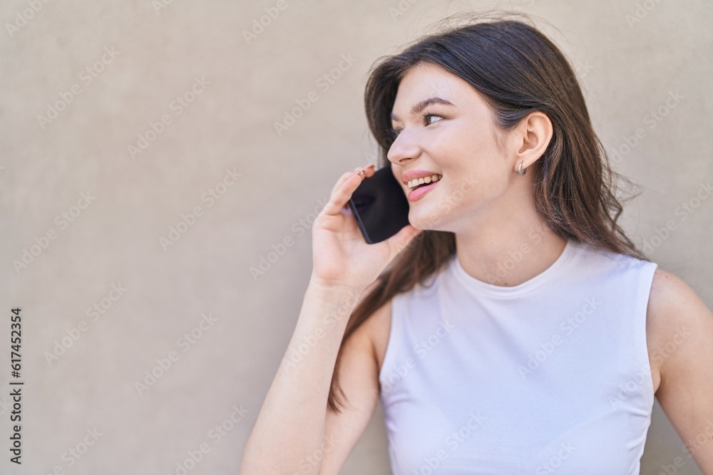 Young caucasian woman smiling confident talking on the smartphone over isolated white background Young caucasian woman smiling confident talking on the smartphone over isolated white background