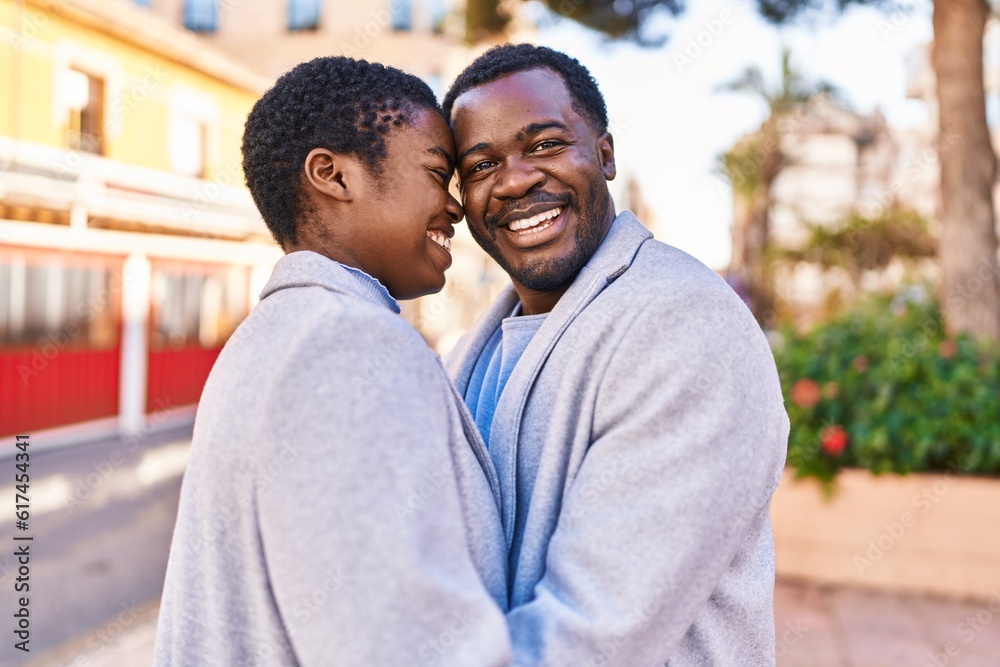 Man and woman couple hugging each other standing at street Man and woman couple hugging each other standing at street
