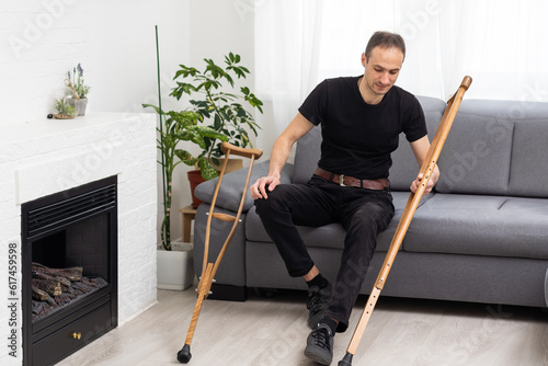 Young man with axillary crutches