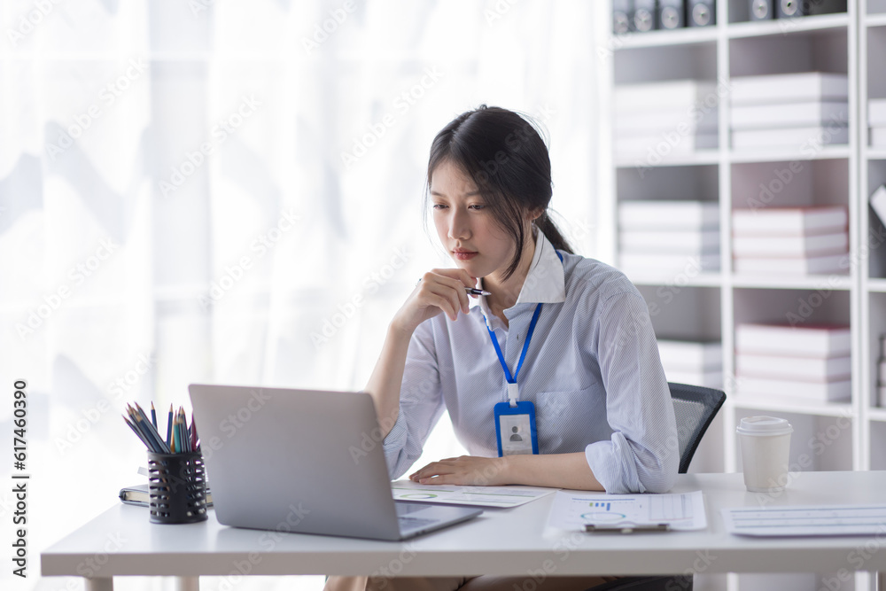 Business Asian woman work documents on laptop computer at office with calculator accounting on desk, do planning analyzing the financial report, business plan investment, finance analysis concept. Business Asian woman work documents on laptop computer at office with calculator accounting on desk, do planning analyzing the financial report, business plan investment, finance analysis concept.