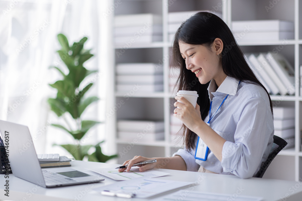 Business Asian woman work documents on laptop computer at office with calculator accounting on desk, do planning analyzing the financial report, business plan investment, finance analysis concept. Business Asian woman work documents on laptop computer at office with calculator accounting on desk, do planning analyzing the financial report, business plan investment, finance analysis concept.