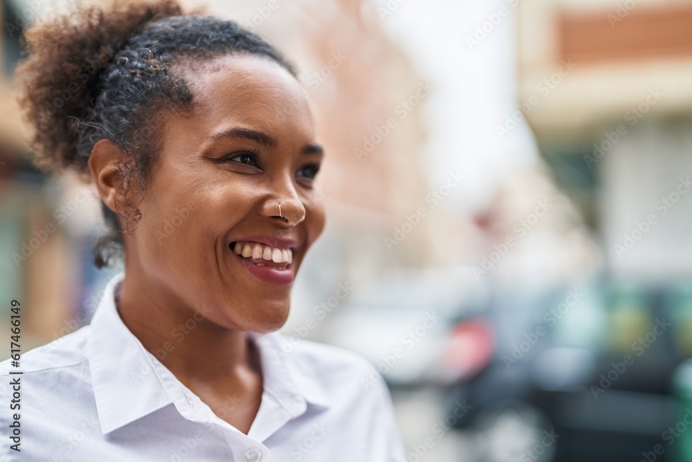 African american woman smiling confident looking to the side at street