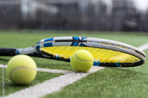 Close up of tennis rackets and tennis balls lying on tennis court. sport, tennis and activity. © Angelov