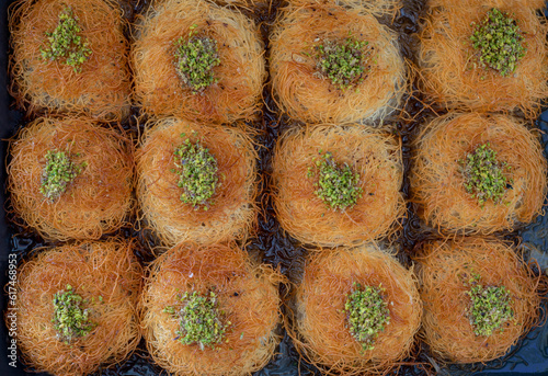 Obraz na płótnie close up turkish dessert kadayif. shredded wheat dessert with pistachio filling w salonie