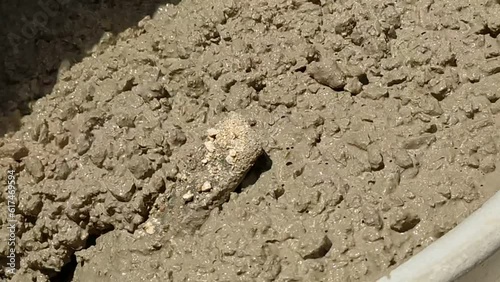 Powerful Mixing: Close Up of Cement Mixer Mixing Concrete.