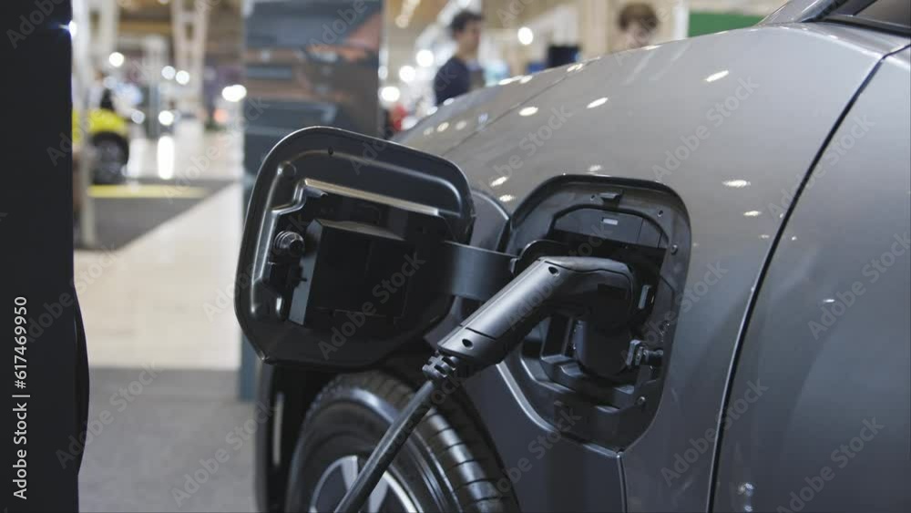 An electro car on charge at the charging station indoors An electro car on charge at the charging station indoors