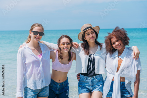 Happy children laughing and enjoying at beach. Teenage playing with friends at the sea. Vacations time and friendship concept. © NewSaetiew