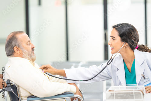 Professional Medical Doctor diagnosing and giving advice to the elderly patient at hospital.