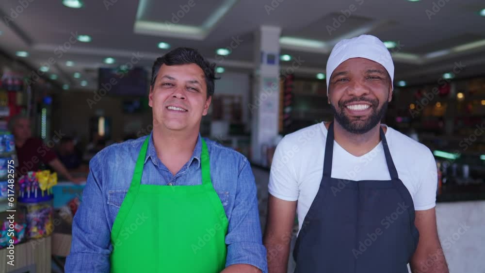 Portrait of a small business manager with employee, job occupation concept of restaurant cafeteria. Two people wearing apron smiling at camera
