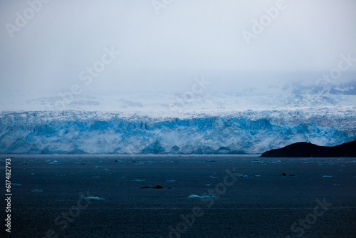 Cruise to Hubbard Glacier Bay in Alaska with floating ice bergs and drift ice floes on ocean water surface surrounded by snow cap mountains and wildlife wild nature scenery Last Frontier adventure