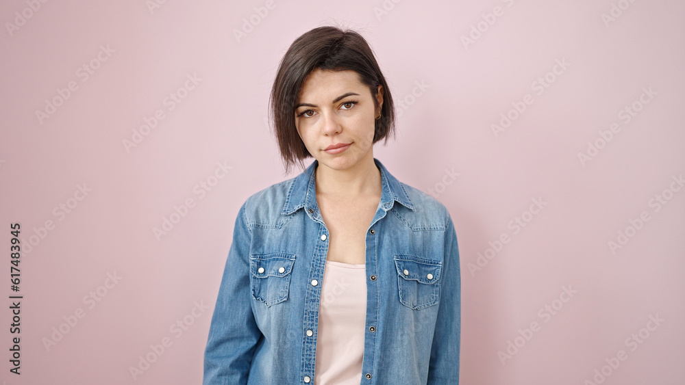 Young caucasian woman standing with serious expression over isolated pink background Young caucasian woman standing with serious expression over isolated pink background