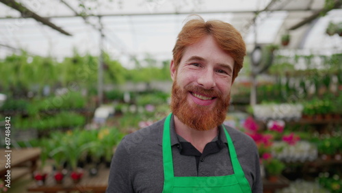Portrait of a Smiling Red-Haired Male Employee smiling at camera in Flower Shop
