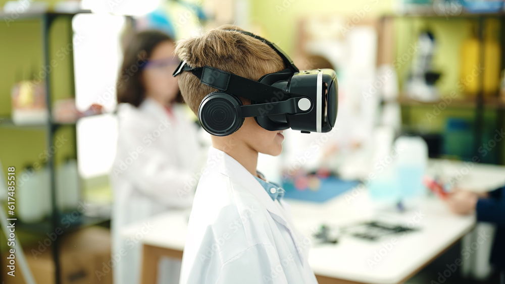 Adorable caucasian boy student using virtual reality glasses at laboratory classroom Adorable caucasian boy student using virtual reality glasses at laboratory classroom