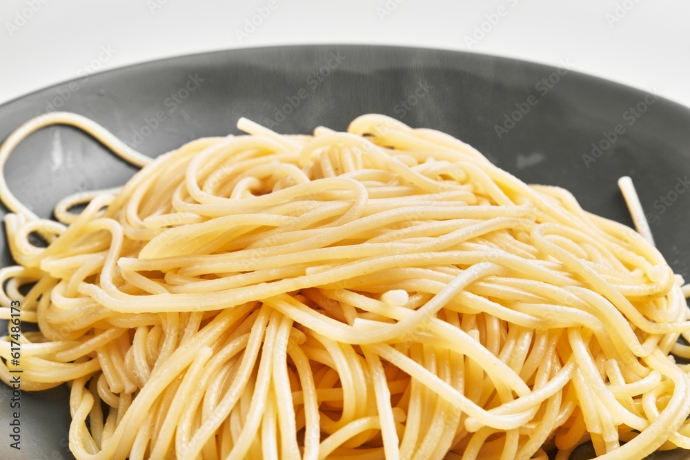Delicious plate of italian spaghetti pasta over isolated white background Delicious plate of italian spaghetti pasta over isolated white background