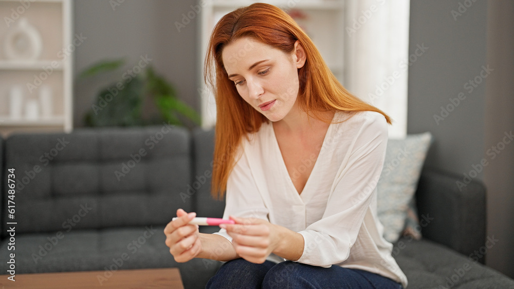 Young redhead woman waiting pregnancy test result at home Young redhead woman waiting pregnancy test result at home