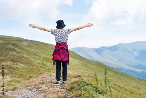 The girl feels freedom, a surge of new strength, great inspiration while resting in the mountains in the fresh air, rests away from the city to gain strength