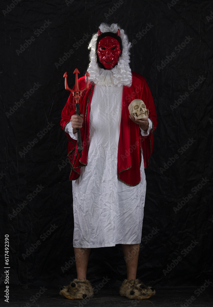 devil in a red robe on a black background