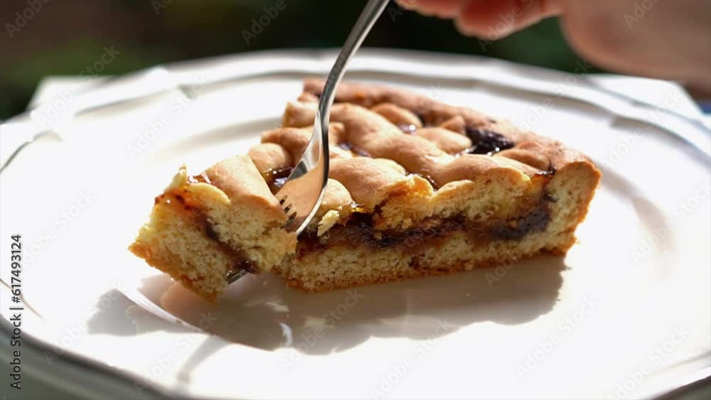 Women eating crostata (Italian jam tart) with a fork Women eating crostata (Italian jam tart) with a fork