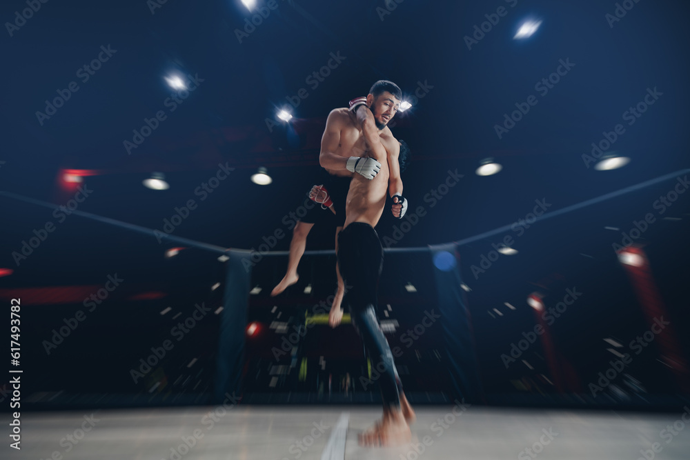 MMA Boxers fighters in fights without rules in ring cargo octagon hit throw wrestling, dark background spot light