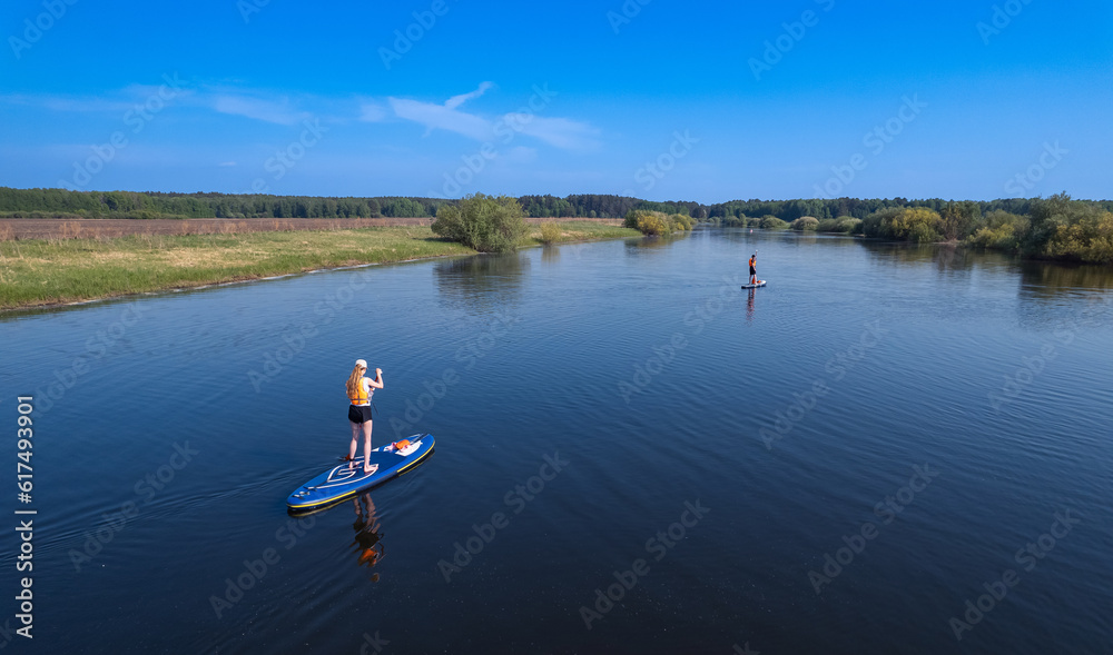 Active fun, Woman floats on river on supboard. Concept summer lifestyle sport for fun