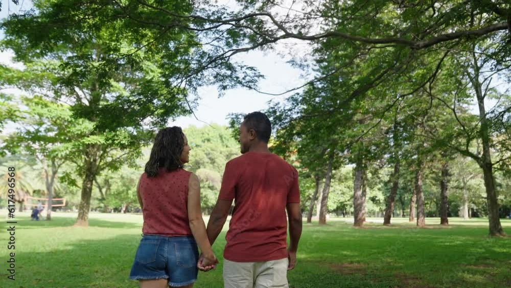 Young positive latin couple walking holding hands date in summer city park. Man and woman enjoying spend time together
Young positive latin couple walking holding hands date in summer city park. Man and woman enjoying spend time together