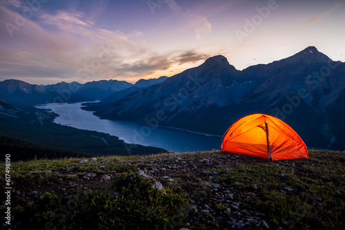 Glowing tent set up on a ridge for camping in the Rocky mountains