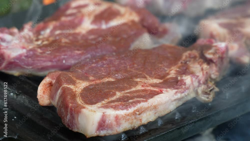 Fresh pork meat on the grill close up hand held video