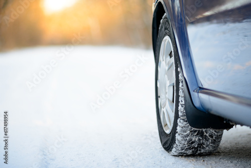 Close-up Image of Winter Car Tire on the Snowy Road. Drive Safe Concept.