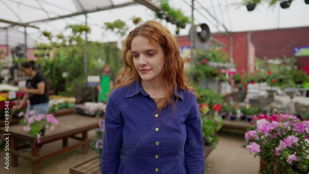 Woman walking through Flower Shop isle at local business retail store