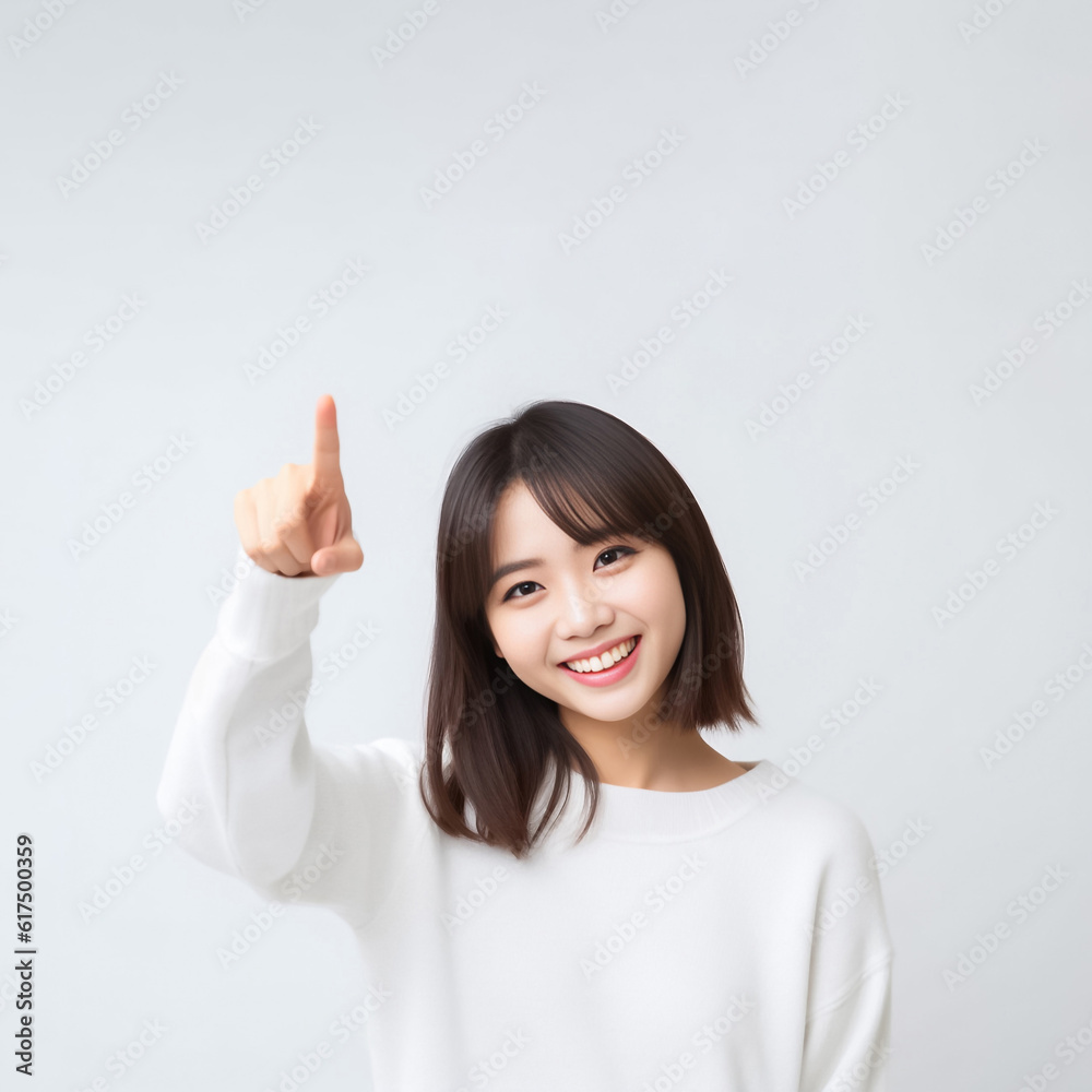 Pointing finger of an Asian girl highlights vacant space on a white background, making it a prime choice for a promotional advertising banner. Generative AI. Pointing finger of an Asian girl highlights vacant space on a white background, making it a prime choice for a promotional advertising banner. Generative AI.