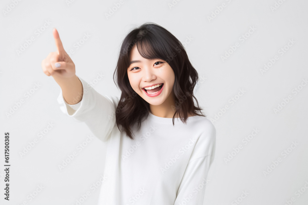 Pointing finger of an Asian girl highlights vacant space on a white background, making it a prime choice for a promotional advertising banner. Generative AI. Pointing finger of an Asian girl highlights vacant space on a white background, making it a prime choice for a promotional advertising banner. Generative AI.