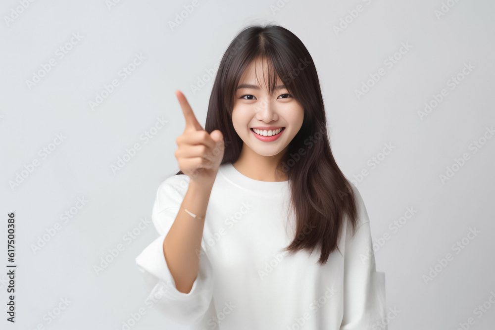 Pointing finger of an Asian girl highlights vacant space on a white background, making it a prime choice for a promotional advertising banner. Generative AI. Pointing finger of an Asian girl highlights vacant space on a white background, making it a prime choice for a promotional advertising banner. Generative AI.